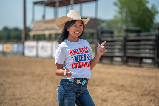 America Needs Cowgirls Graphic Tee